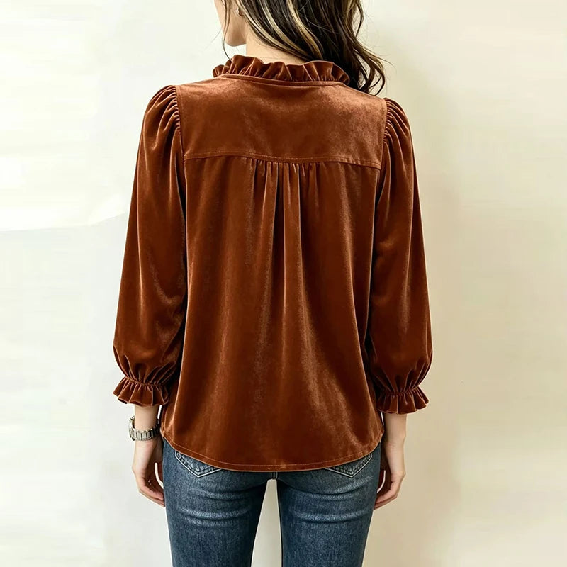 Back view of rust velvet ruffle collar blouse showing gathered yoke