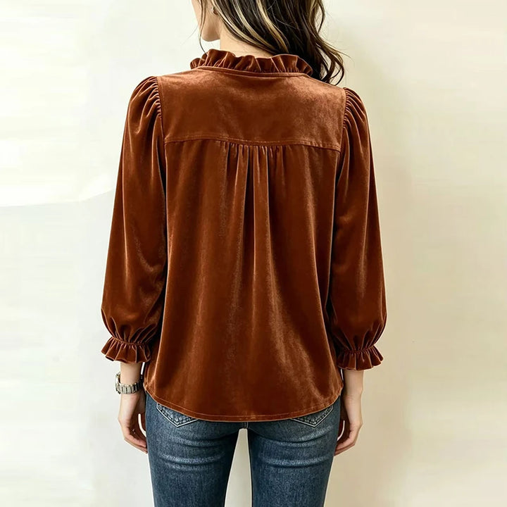 Back view of rust velvet ruffle collar blouse showing gathered yoke