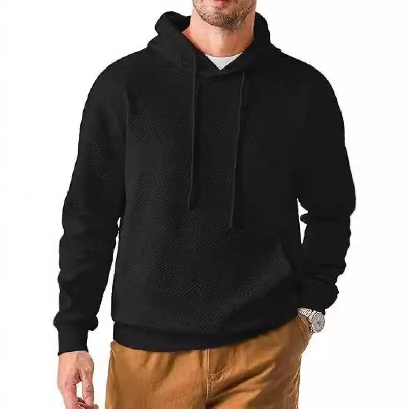 Man wearing black textured knit pullover hoodie