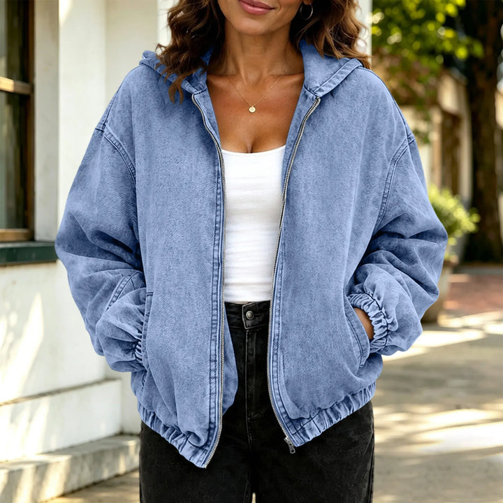 Woman wearing sky blue hooded denim jacket, close up view