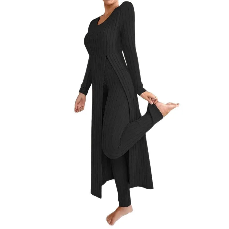 Woman wearing black ribbed long slit two piece loungewear set on white background