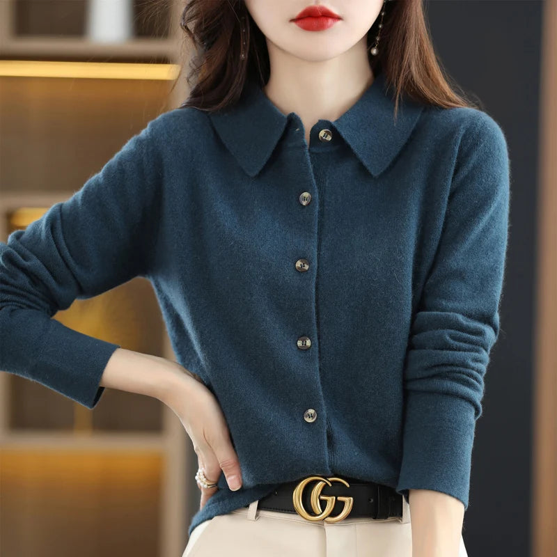 Teal blue knit cardigan with hand on hip