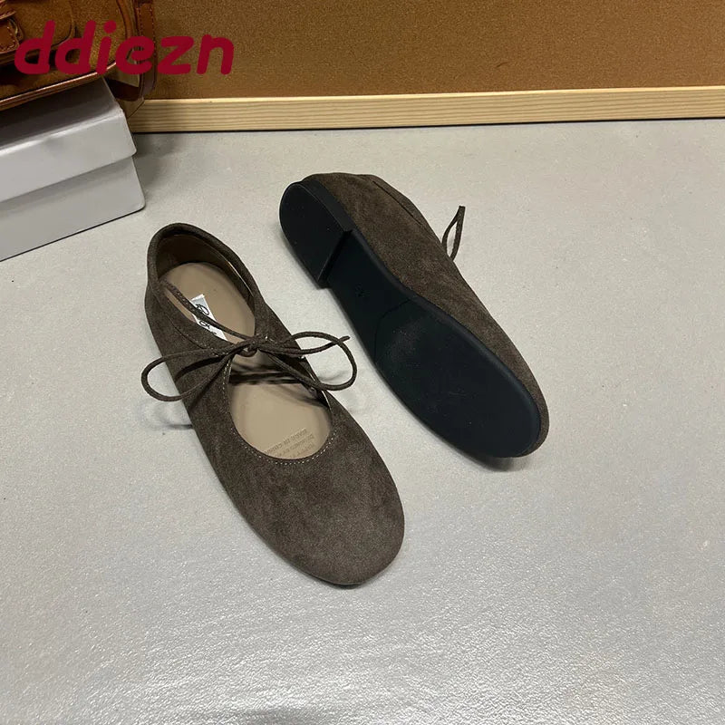 Brown suede-look ballet flats showing sole and side profile