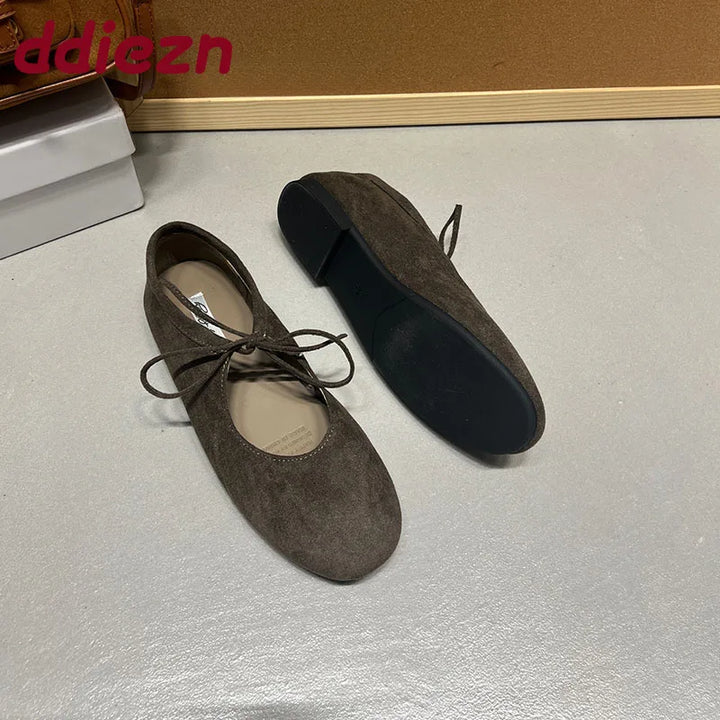 Brown suede-look ballet flats showing sole and side profile
