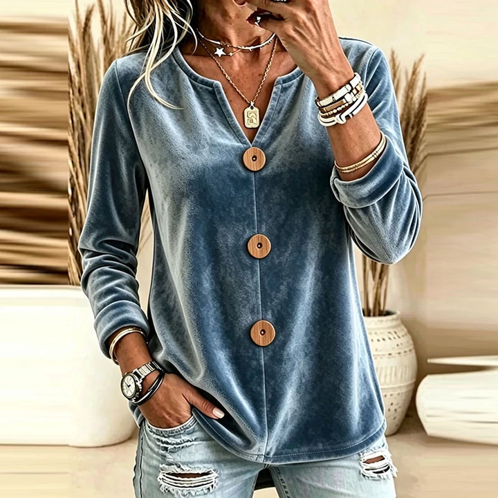 Blue velvet V-neck blouse with wood-tone buttons, front view