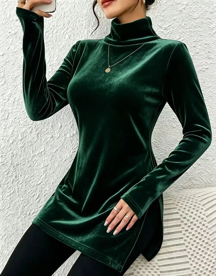Woman wearing green velvet high collar long sleeve top with side slit