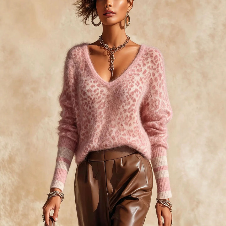 Woman wearing pink leopard print V-neck sweater with striped cuffs