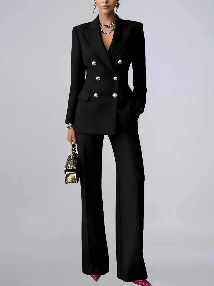 Woman wearing black double breasted pantsuit against grey background