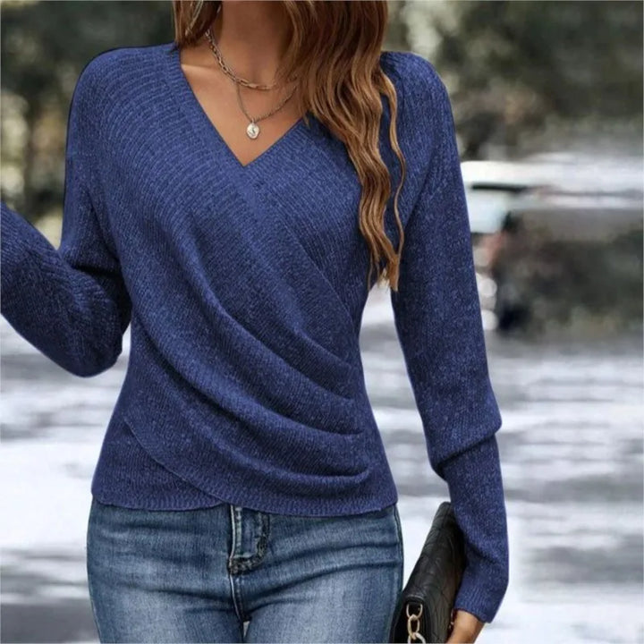 Woman wearing navy blue ribbed knit wrap-front sweater with V-neck