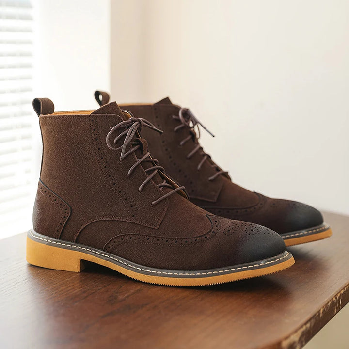 Side view of brown wingtip brogue lace-up ankle boots on wood table