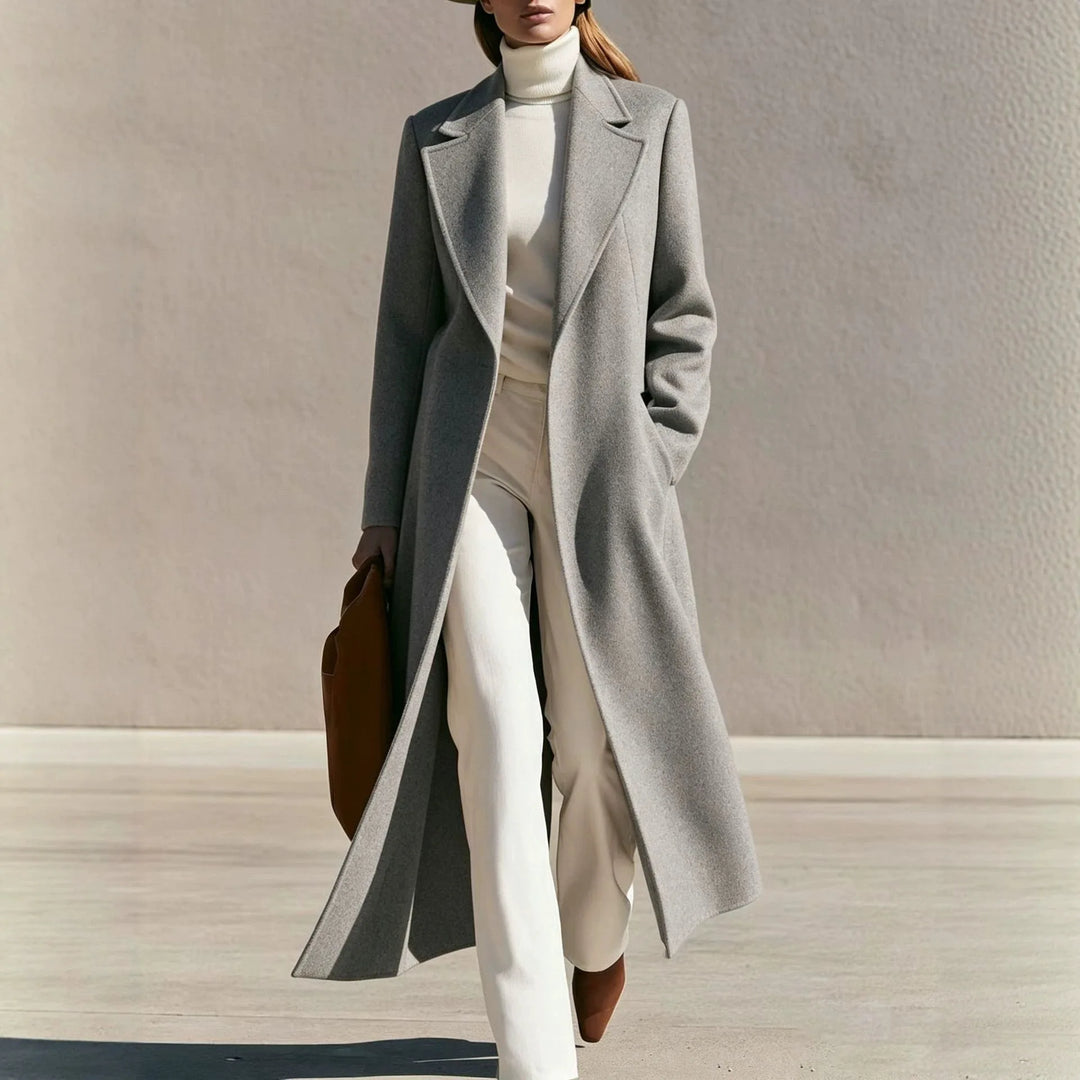 Woman wearing long gray wool-blend coat with notched lapel walking outdoors
