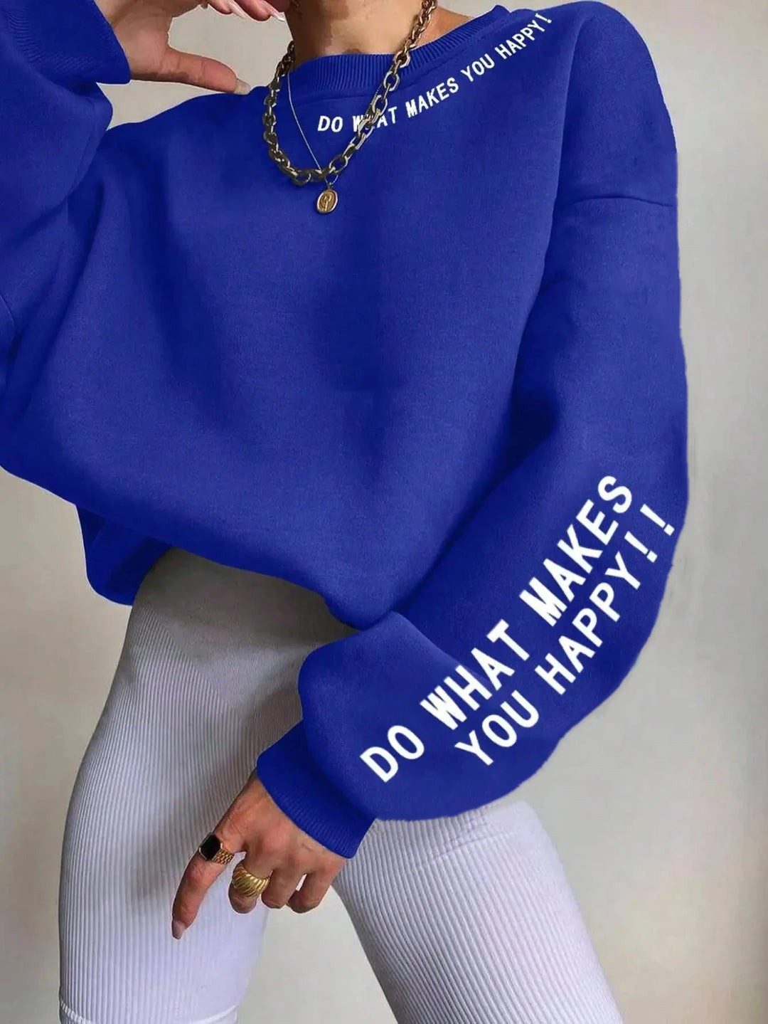 Woman wearing royal blue graphic sweatshirt with sleeve print