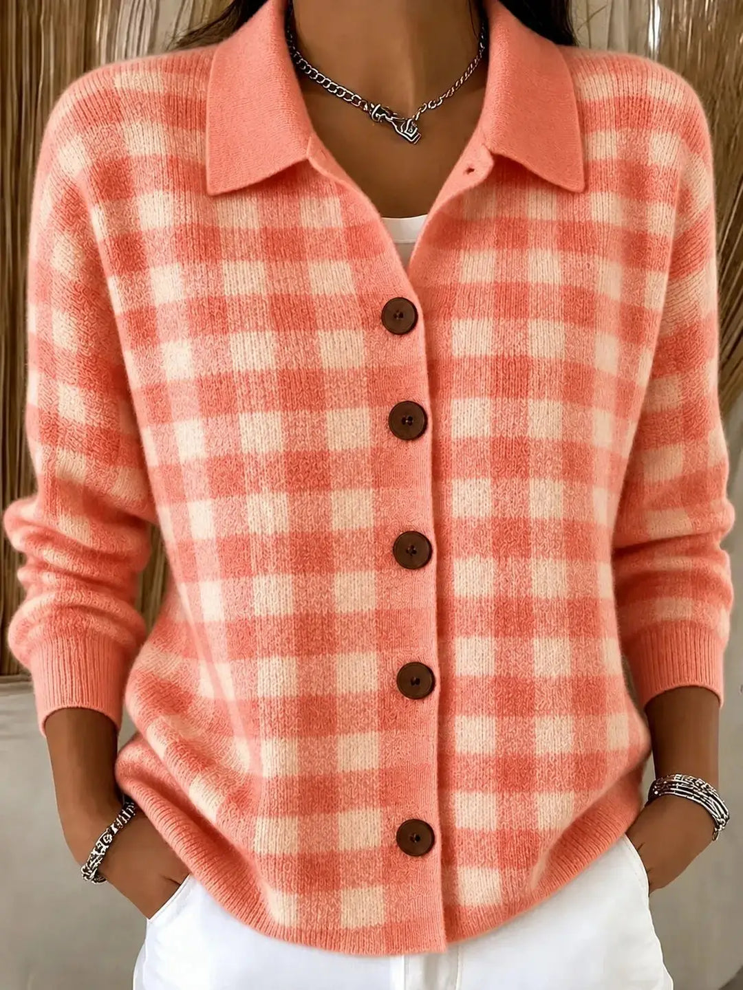 Woman wearing coral gingham knit cardigan with collar and button front