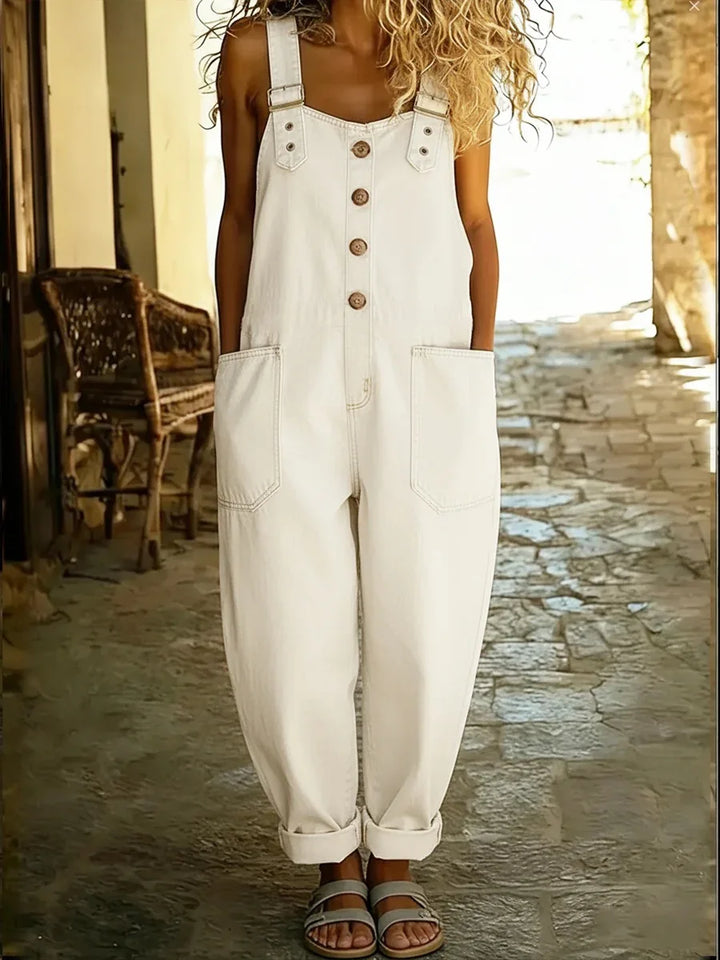 White denim overalls with adjustable straps and rolled ankle cuffs