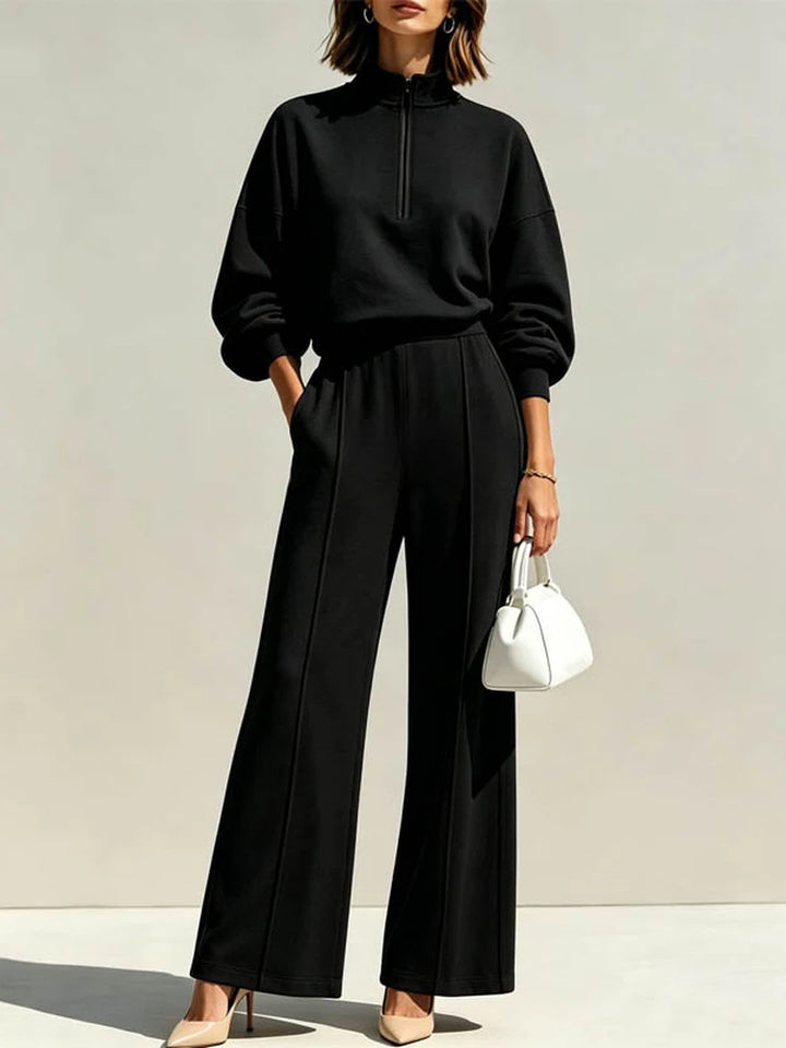 Woman wearing black quarter zip pullover and wide leg pant set