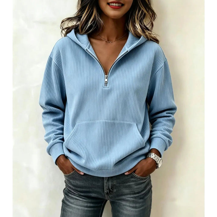Woman wearing sky blue ribbed half-zip hoodie with kangaroo pocket