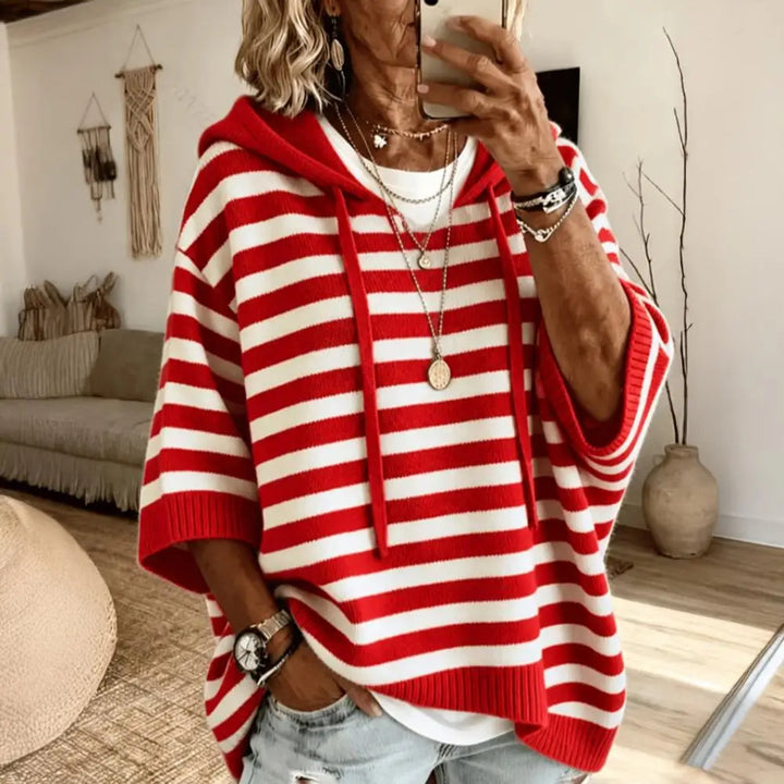 Woman wearing red and white striped hooded sweater with drawstring