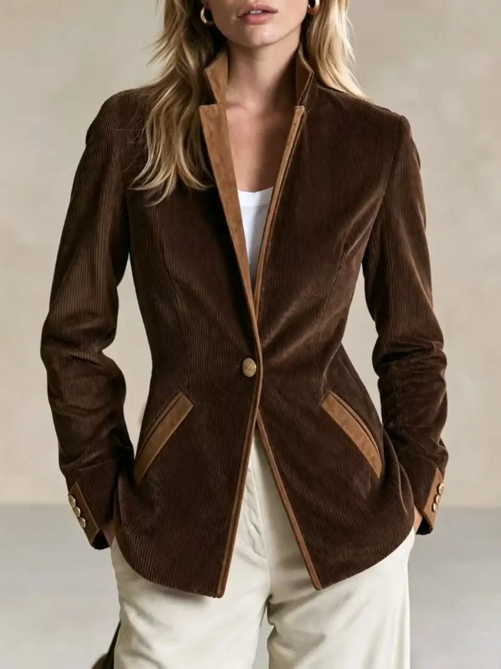 Woman wearing brown corduroy blazer with suede trim, front view