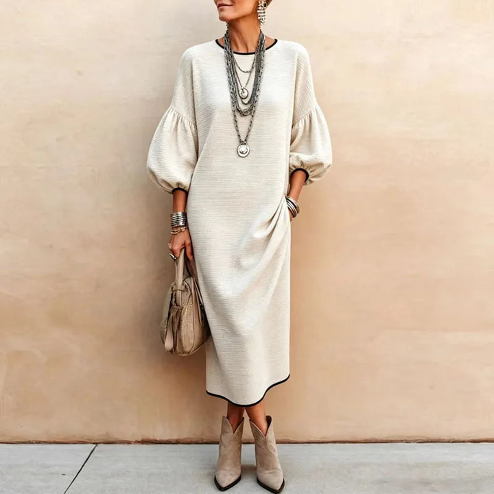 Front view of apricot knit maxi dress with round neckline and pockets