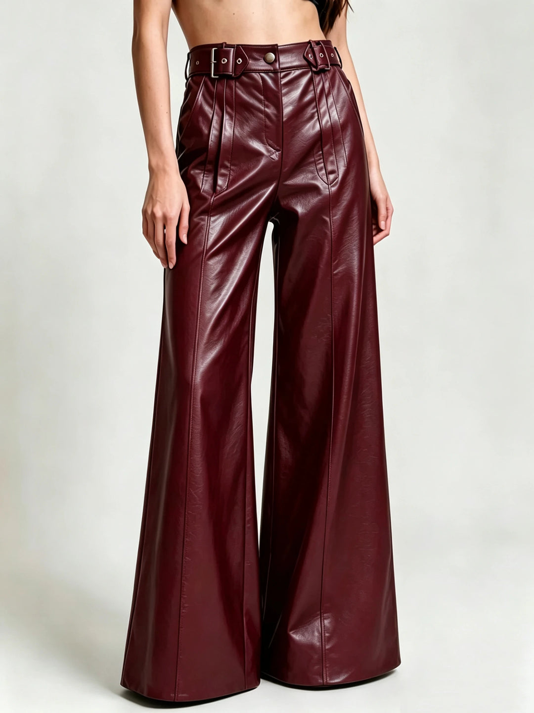 Burgundy faux leather wide leg pants with double buckle belt, front view