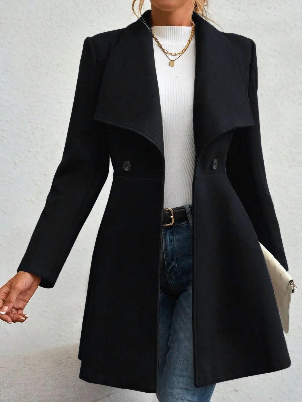 Woman wearing black waterfall collar swing coat, close front view