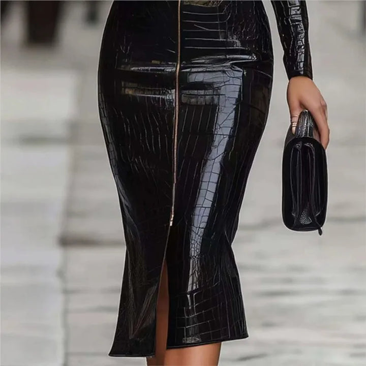 Close up of front hem slit on black croc-textured midi dress