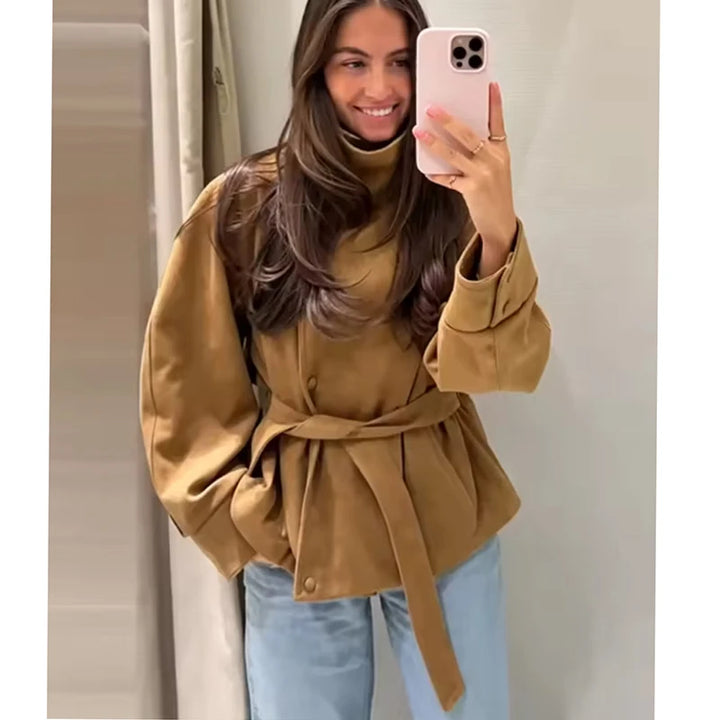 Woman wearing camel belted jacket smiling