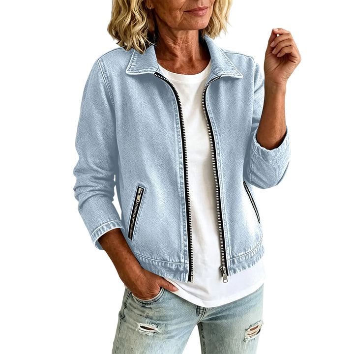 Sky blue denim jacket with zippered pockets on white background