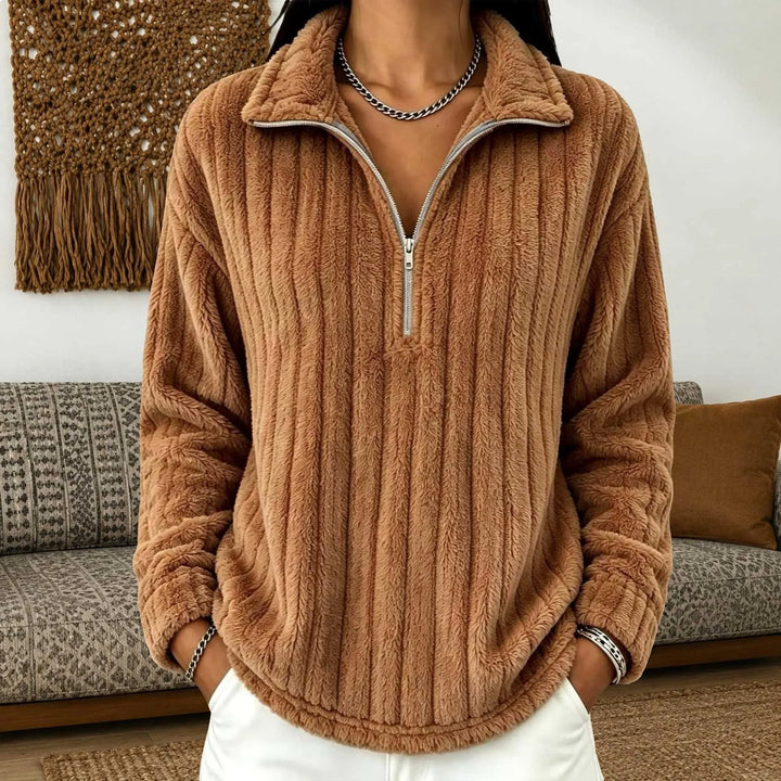 Woman wearing light brown ribbed quarter-zip pullover