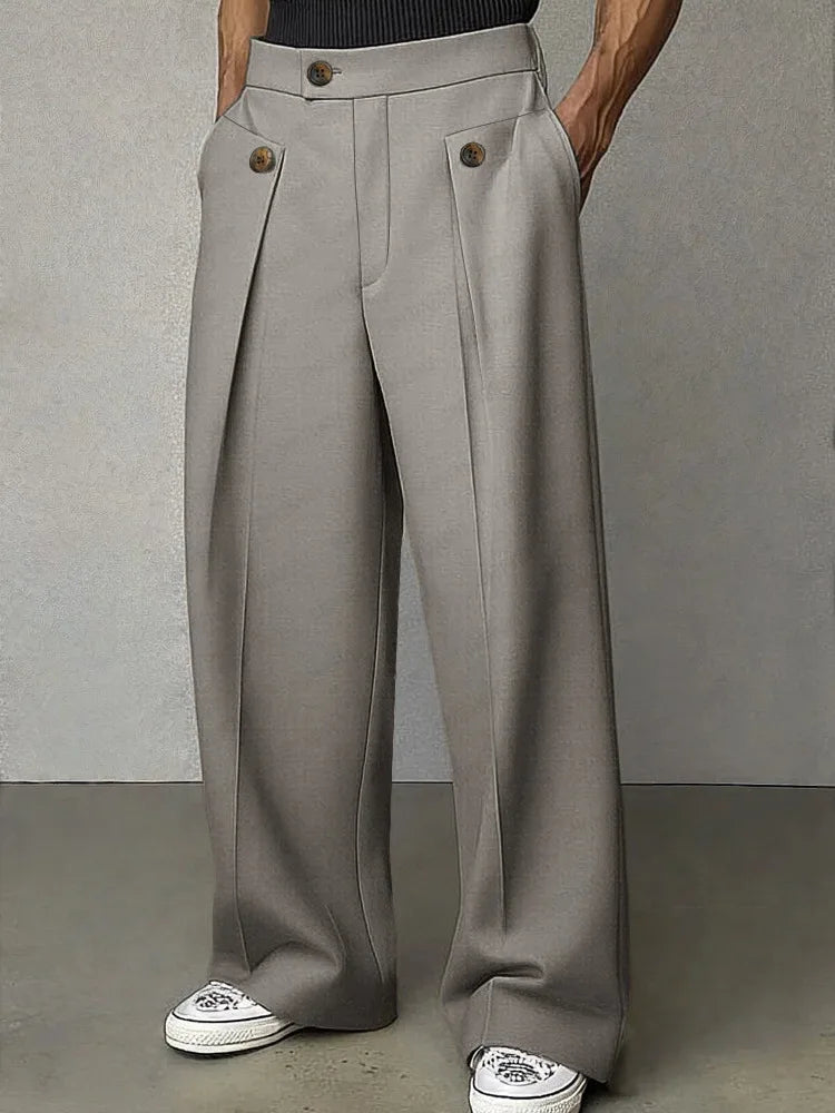 Grey wide leg trousers with button tab pockets, front view