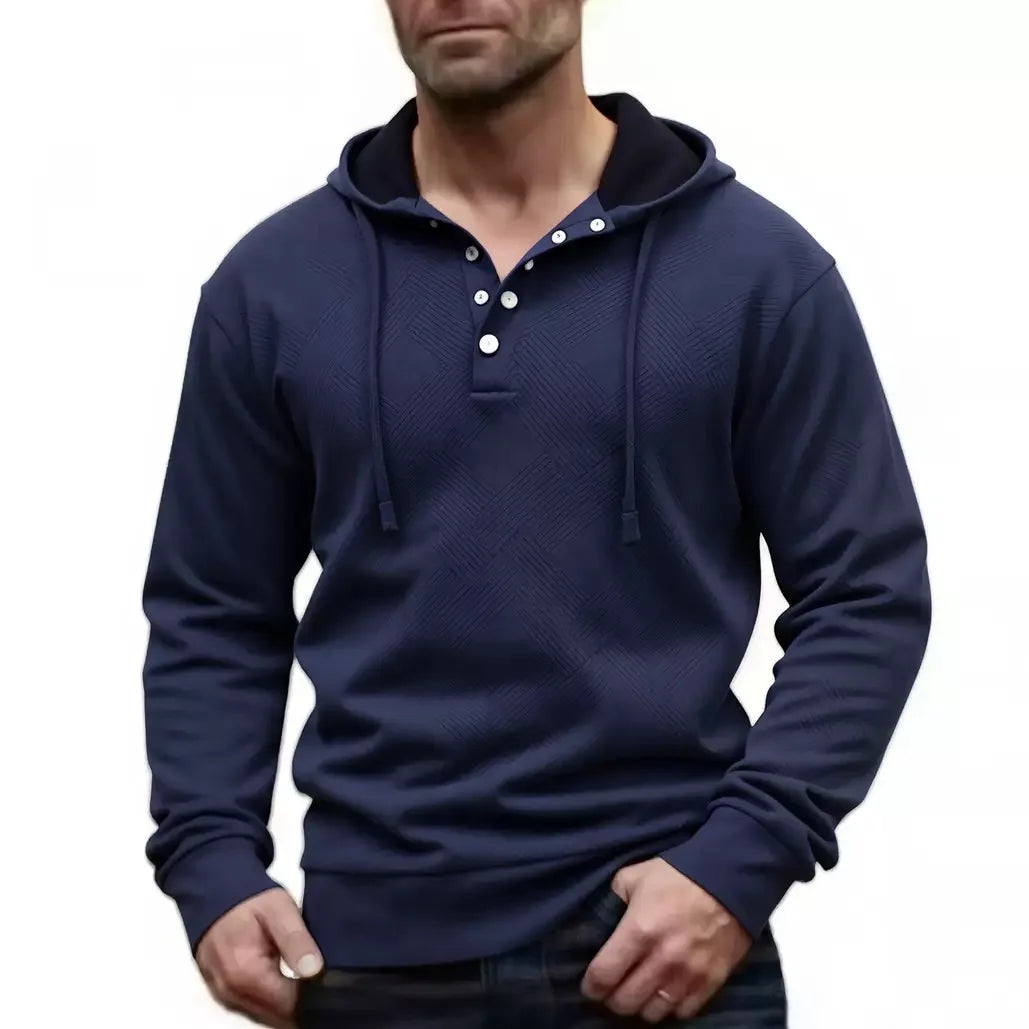 Man wearing navy blue textured knit hoodie with drawstring hood