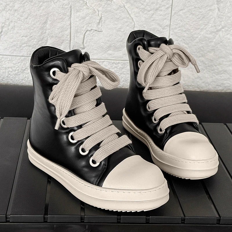 Pair of black high top sneakers with white platform soles and rope laces on display