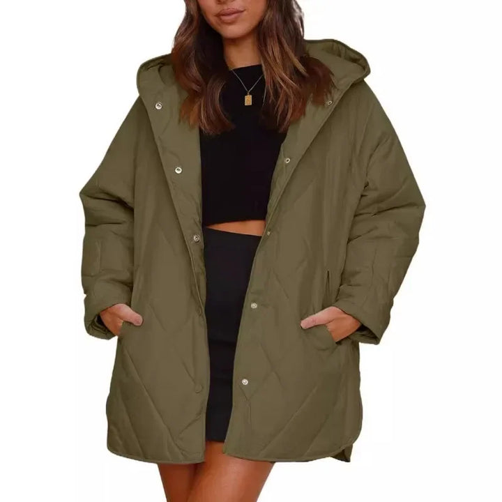 Woman wearing army green diamond quilted hooded jacket with hands in pockets