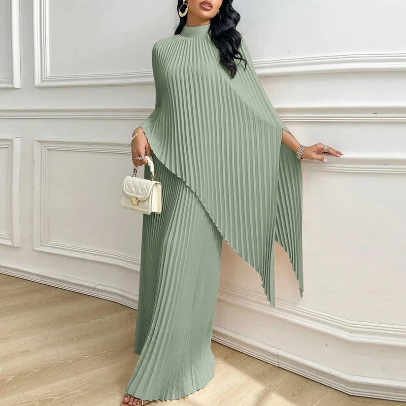 Woman wearing green pleated cape top and wide leg pants two piece set