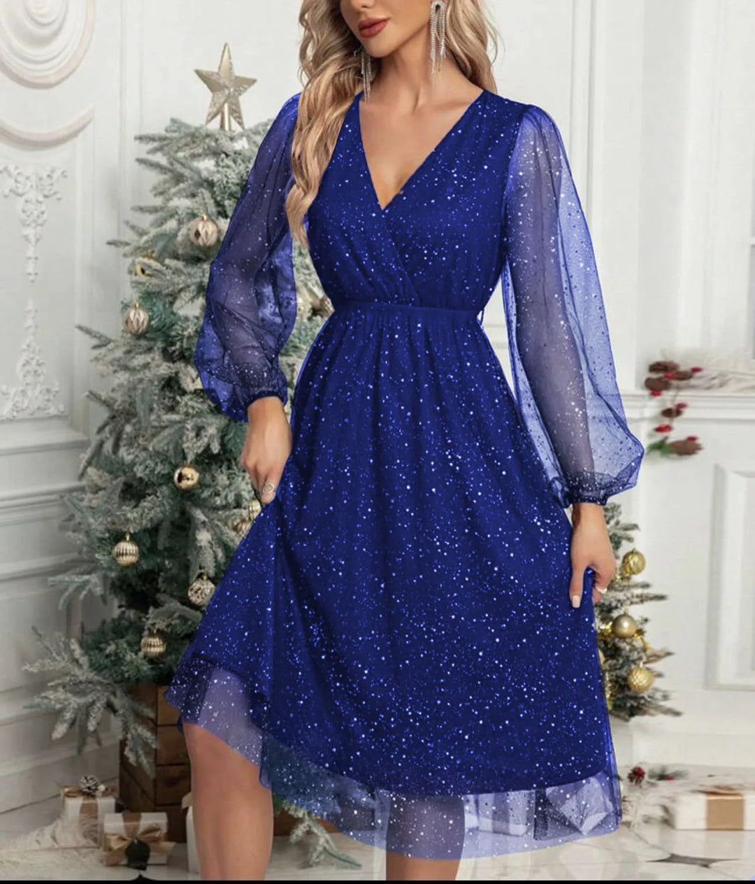 Woman wearing blue glitter mesh wrap dress with balloon sleeves