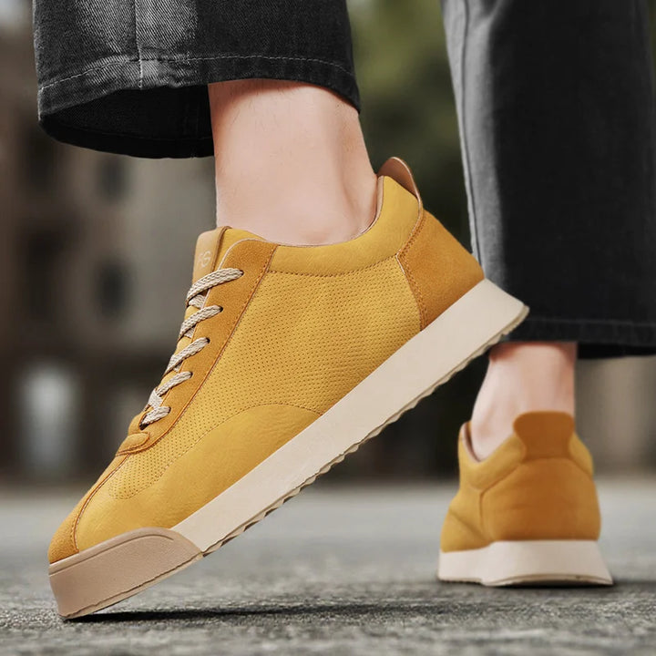 Rear view of yellow sneaker worn on foot walking outdoors