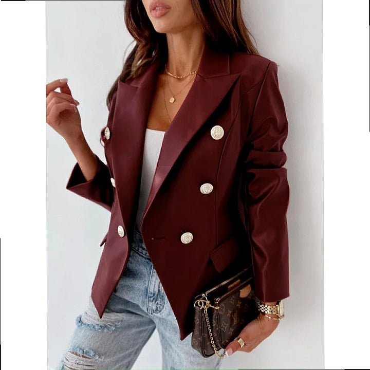 Woman wearing burgundy faux leather double breasted blazer
