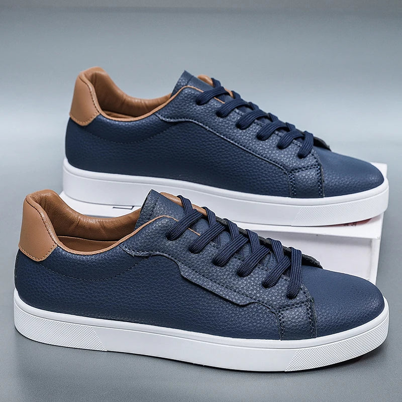 Navy blue leather-look low-top sneakers with contrast heel tab, side view