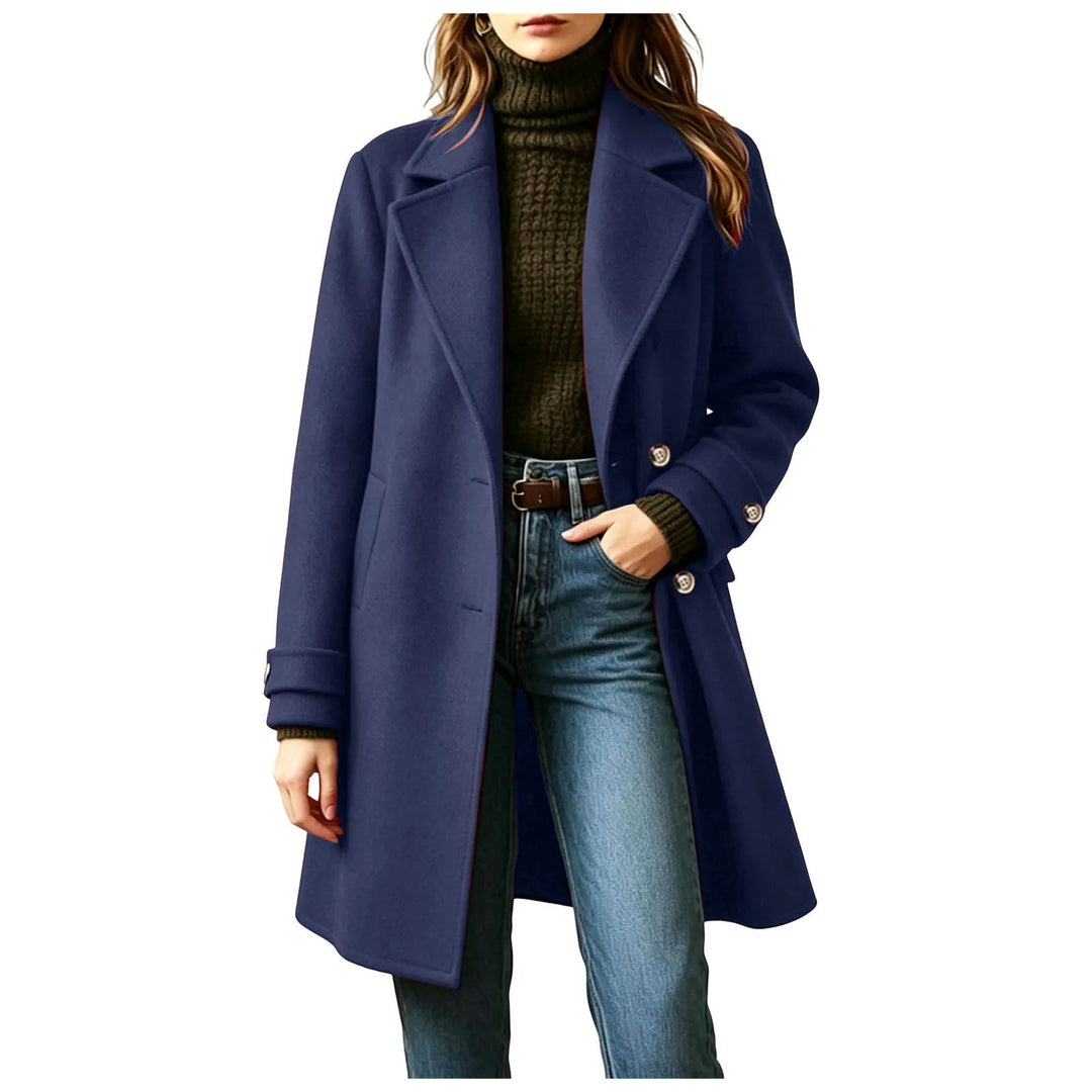 Woman wearing navy blue double-breasted wool coat with buckled cuffs