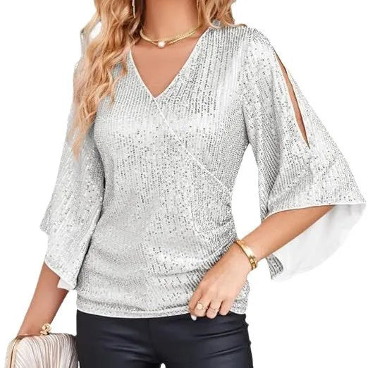 Silver sequin wrap blouse close up on model holding clutch