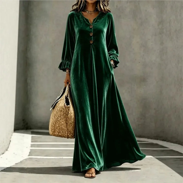 Woman wearing dark green velvet maxi dress, front view