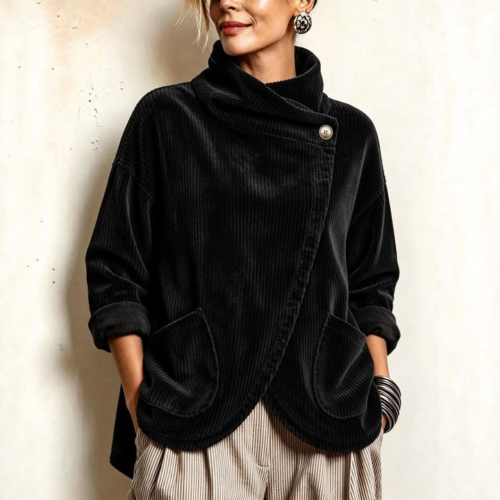 Woman wearing black corduroy jacket with asymmetric button closure