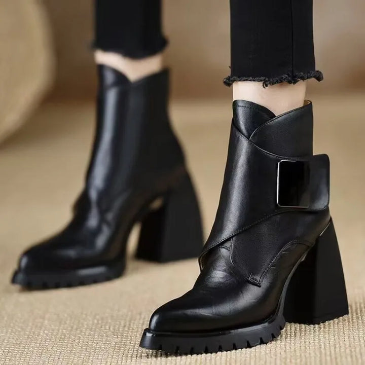 Black ankle boots worn on model, side view
