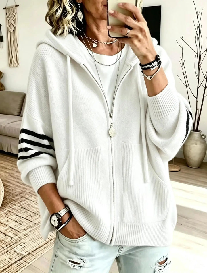 White zip-up knit hoodie with striped sleeve detail and front pockets
