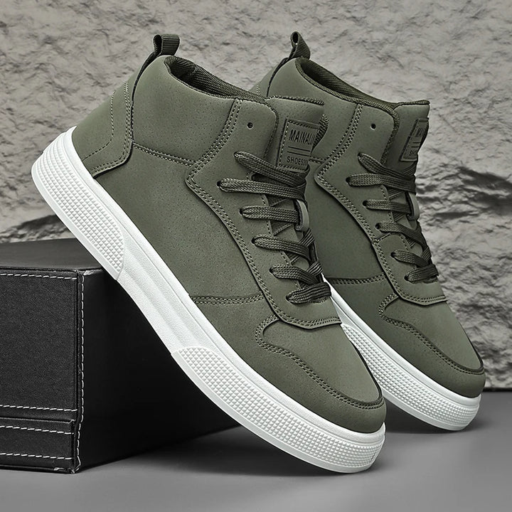 Olive green high-top sneakers leaning on shoe box