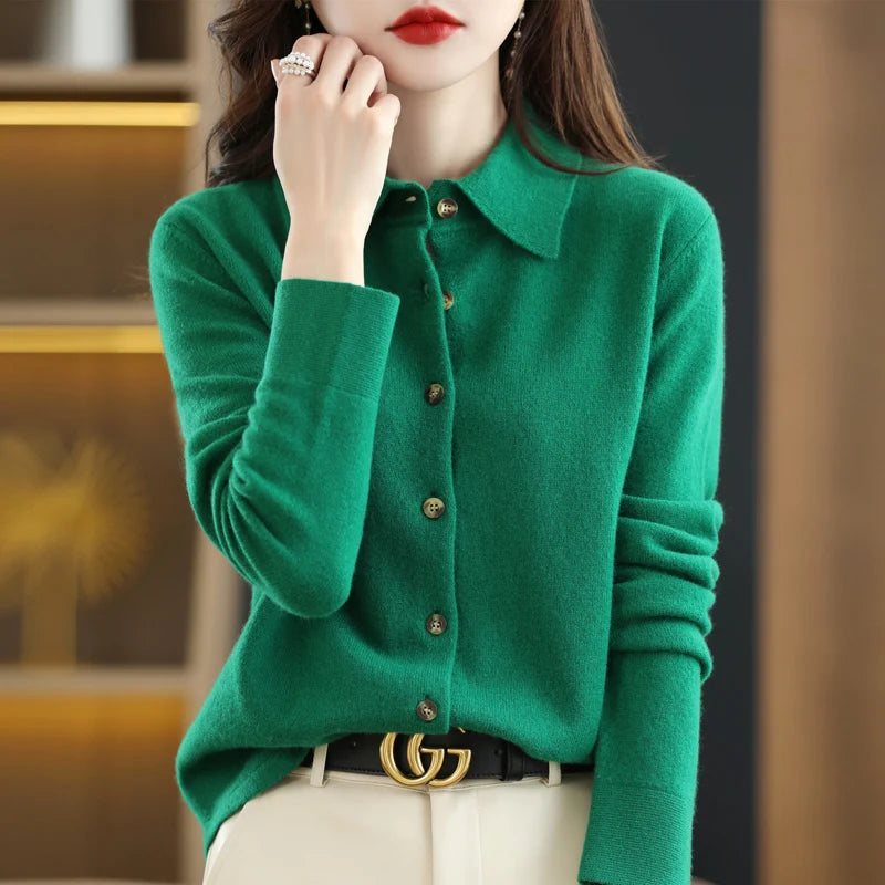 Green knit cardigan with hand near chin