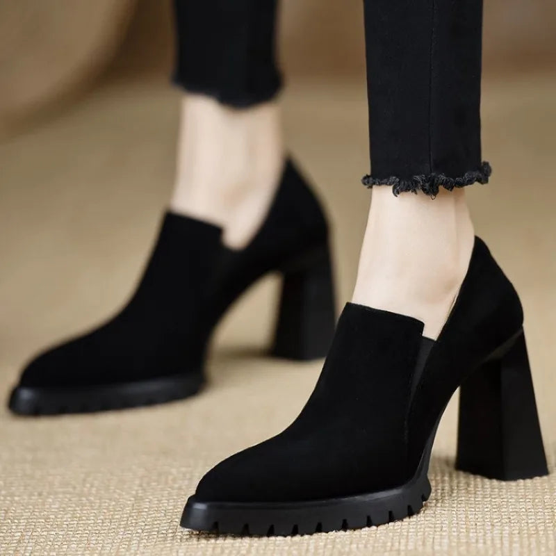 Black suede pointed toe pump, side profile view