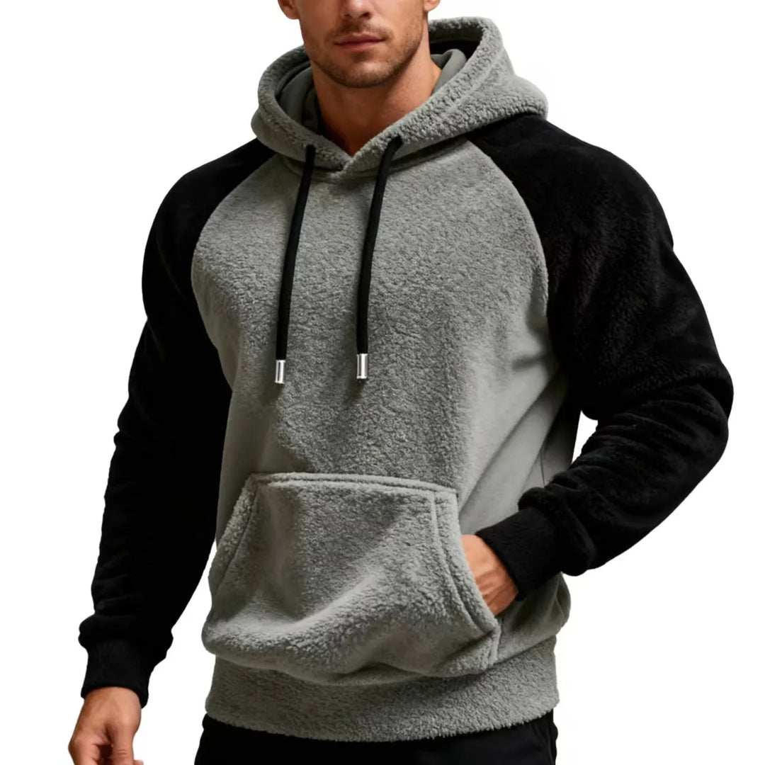 Man wearing gray and black sherpa fleece hoodie with drawstring hood