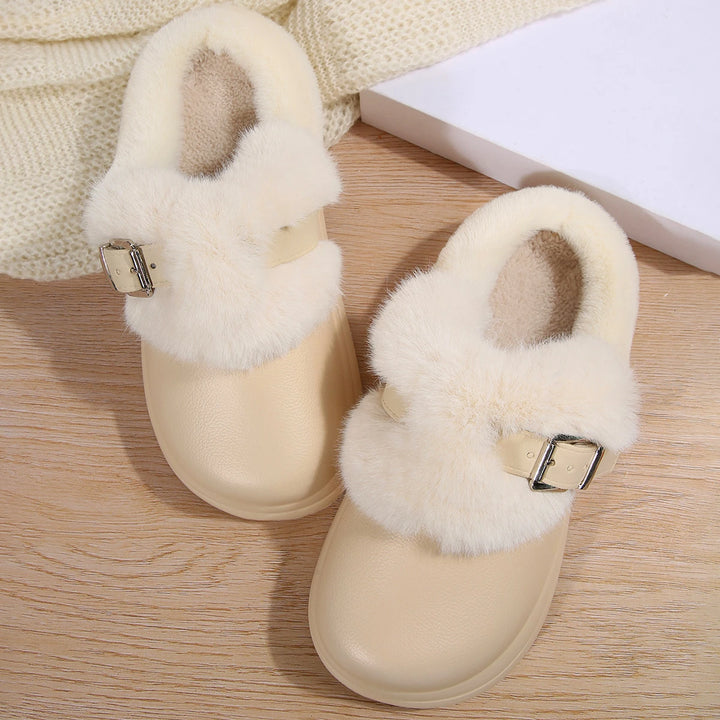 Pair of white faux fur platform clog slippers on wood floor