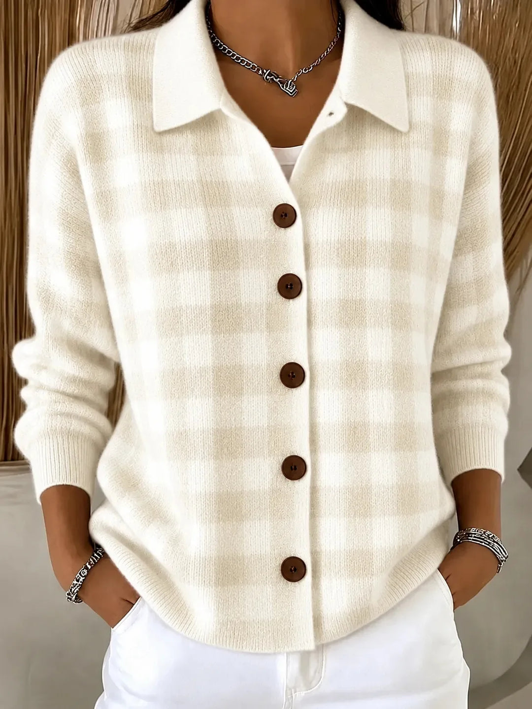 Woman wearing cream gingham knit cardigan with collar and button front